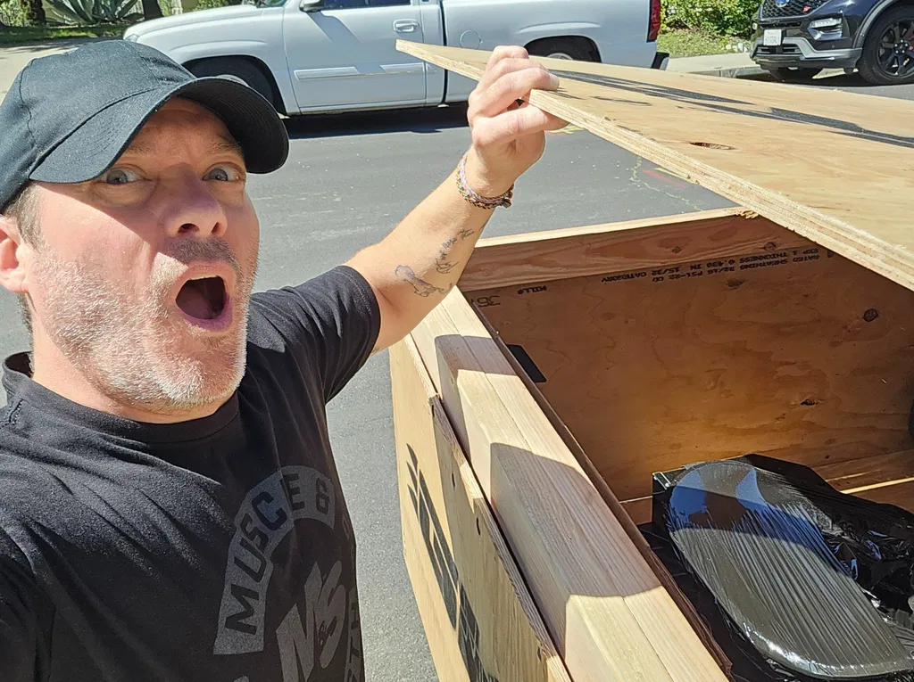 Customer excitedly opening his NIGHTHAWK shipping crate