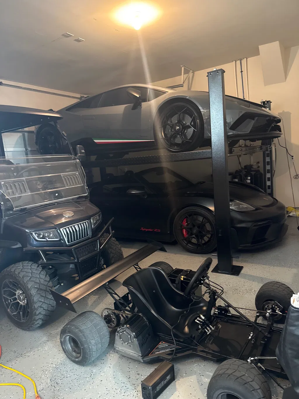 Nick's NIGHTHAWK parked in his garage alongside his sports cars